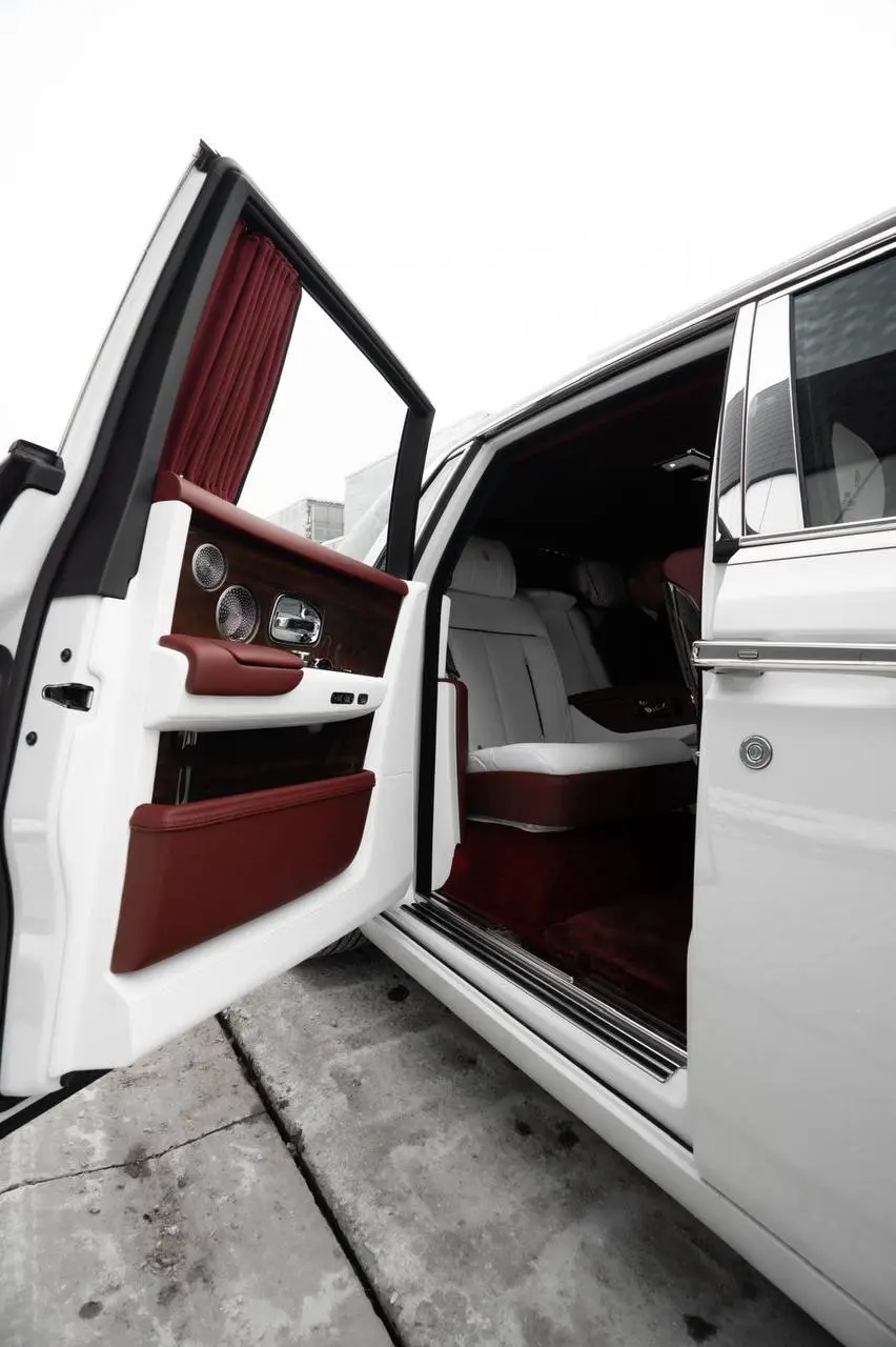 White and burgundy Rolls-Royce passenger cabin